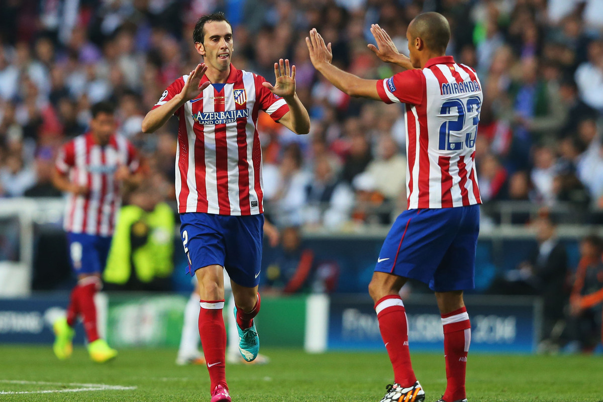 LISBON, PORTUGAL - MAY 24:  Diego Godin of Club Atletico de Madrid is congratulated on scoring the first goal by Miranda of Club Atletico de Madrid during the UEFA Champions League Final between Real Madrid and Atletico de Madrid at Estadio da Luz on May 24, 2014 in Lisbon, Portugal.  (Photo by Alex Livesey/Getty Images)