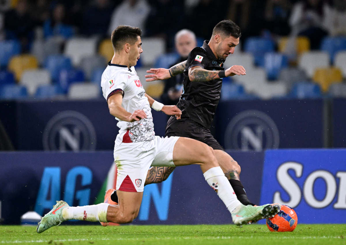 NAPLES, ITALY - DECEMBER 03: Adam Obert of Cagliari battles for possession with Matteo Politano of SSC Napoli during the Coppa Italia round of 16 match between SCC Napoli and Cagliari Calcio at Stadio Diego Armando Maradona on December 03, 2025 in Naples, Italy. (Photo by Francesco Pecoraro/Getty Images)
