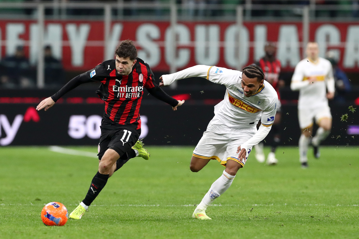 MILAN, ITALY - JANUARY 18: Christian Pulisic of AC Milan runs with the ball whilst under pressure from Corrie Ndaba of US Lecce during the Serie A match between AC Milan and US Lecce at Giuseppe Meazza Stadium on January 18, 2026 in Milan, Italy. (Photo by Marco Luzzani/Getty Images)