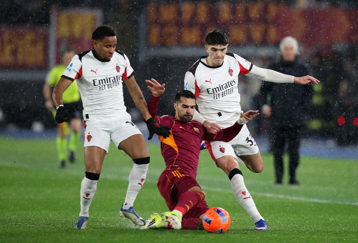 ROME, ITALY - JANUARY 25: Zeki Celik of AS Roma is challenged by Christopher Nkunku and Davide Bartesaghi of AC Milan during the Serie A match between AS Roma and AC Milan at Stadio Olimpico on January 25, 2026 in Rome, Italy. (Photo by Paolo Bruno/Getty Images)
