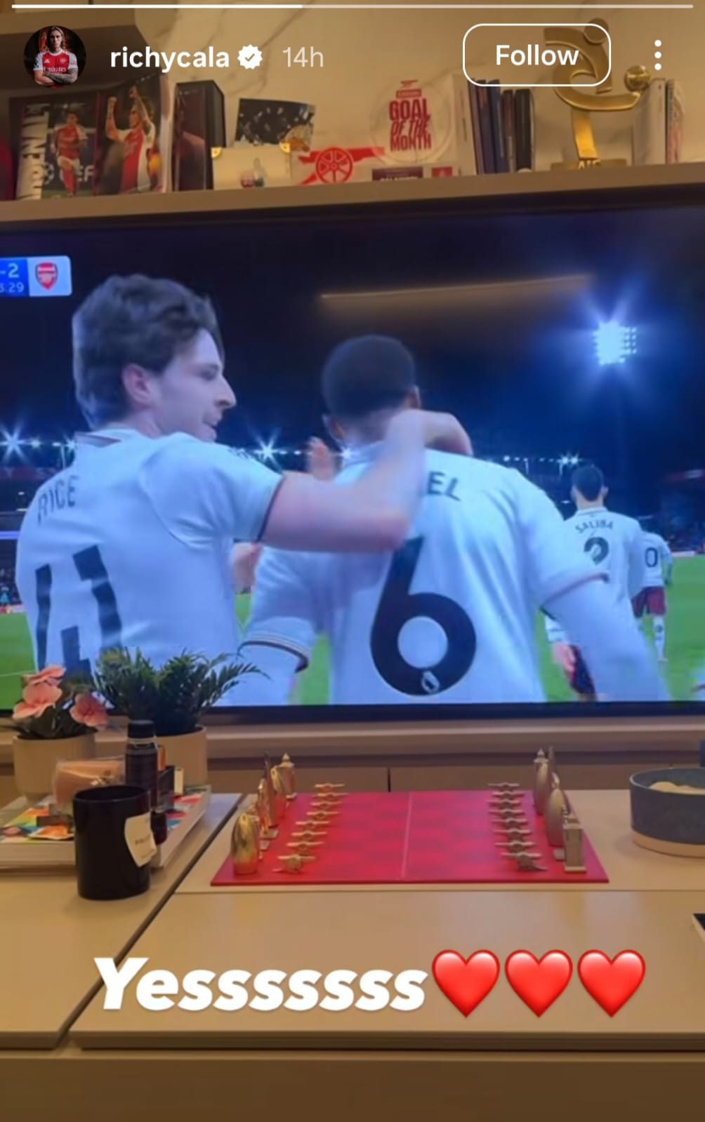Riccardo Calafiori watches Arsenal's 3-2 victory over Bournemouth from his sofa after being left out of the matchday squad through injury (Picture: @richycala via Instagram)