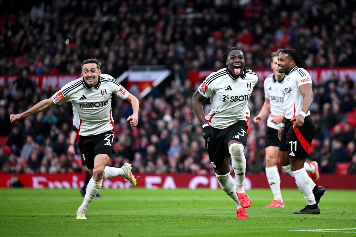 MANCHESTER, ENGLAND - MARCH 02: Calvin Bassey of Fulham celebrates scoring his team's first goal with teammates Timothy Castagne (L) and Adama Traore (R) during the Emirates FA Cup Fifth Round match between Manchester United and Fulham at Old Trafford on March 02, 2025 in Manchester, England. (Photo by Justin Setterfield/Getty Images)