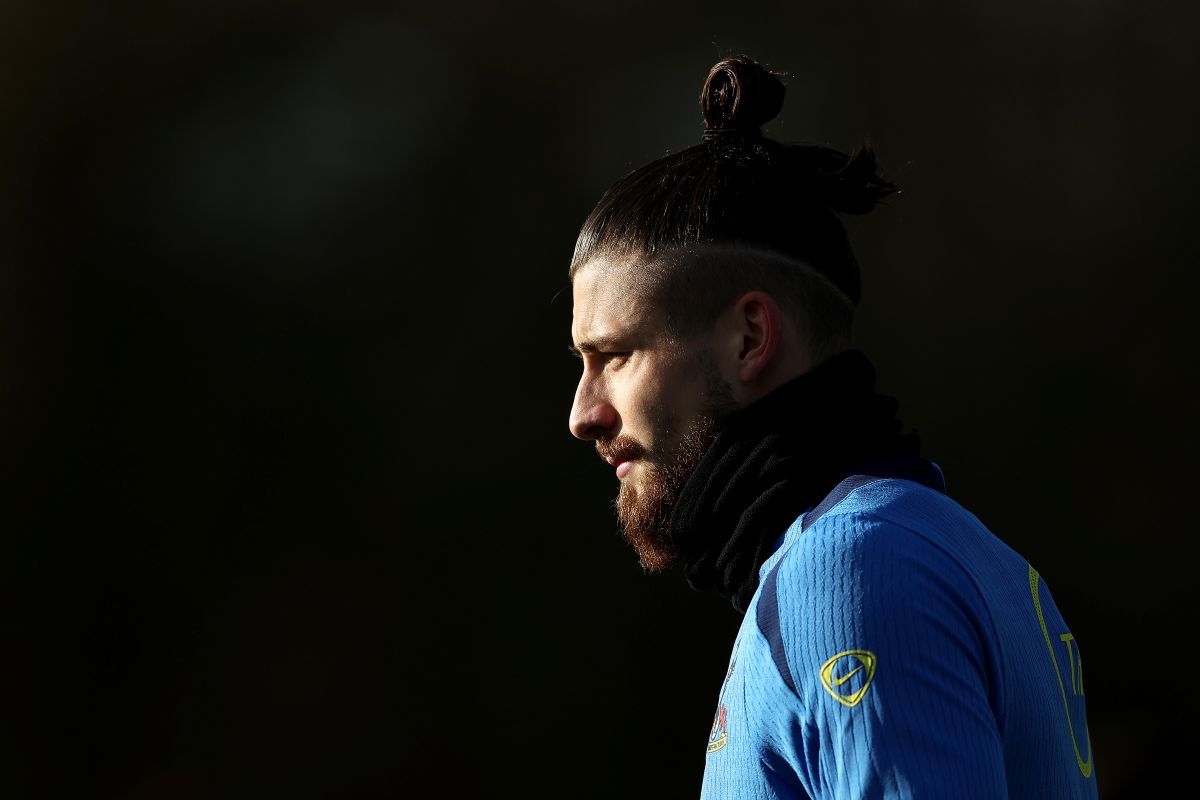 ENFIELD, ENGLAND - NOVEMBER 25: Radu Dragusin of Tottenham Hotspur looks on during a Tottenham Hotspur training session ahead of the UEFA Champions League 2025/26 League Phase MD5 match against Paris Saint-Germain at Tottenham Hotspur Training Centre on November 25, 2025 in Enfield, England. (Photo by James Fearn/Getty Images)