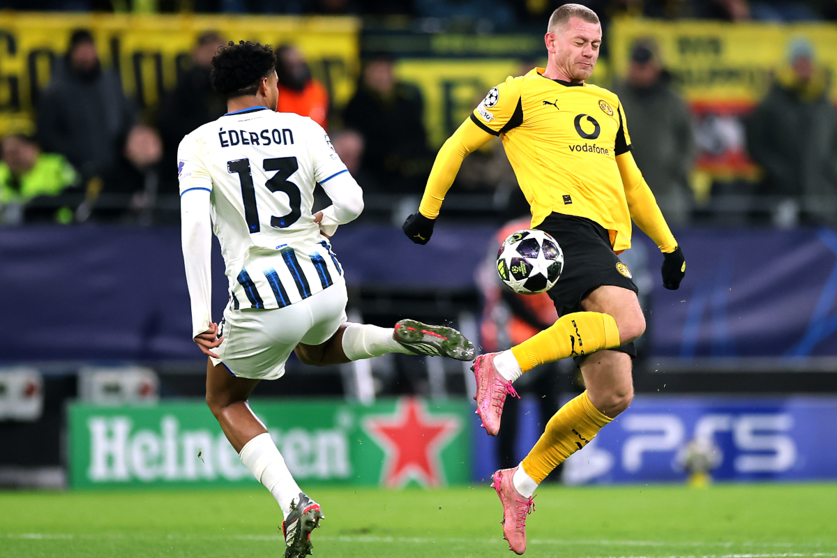 DORTMUND, GERMANY - FEBRUARY 17: Ederson of Atalanta clashes with Julian Ryerson of Borussia Dortmund during the UEFA Champions League 2025/26 League Knockout Play-off First Leg match between Borussia Dortmund and Atalanta BC at BVB Stadion Dortmund on February 17, 2026 in Dortmund, Germany. (Photo by Alex Grimm/Getty Images)