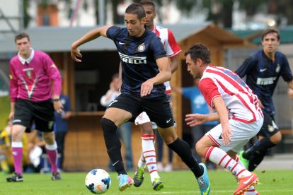 TRENTO, ITALY - JULY 22: Ishak Belfodil (L) of Internazionale Milano competes with Nicolas Giani (R) of Vicenza Calcio during the pre-season friendly match between FC Internazionale Milano and Vicenza Calcio on July 22, 2013 in Pinzolo near Trento, Italy. (Photo by Dino Panato/Getty Images)