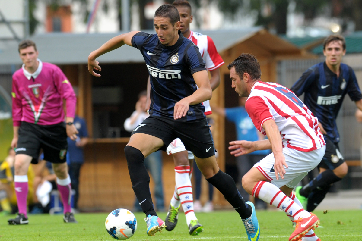 TRENTO, ITALY - JULY 22: Ishak Belfodil (L) of Internazionale Milano competes with Nicolas Giani (R) of Vicenza Calcio during the pre-season friendly match between FC Internazionale Milano and Vicenza Calcio on July 22, 2013 in Pinzolo near Trento, Italy. (Photo by Dino Panato/Getty Images)