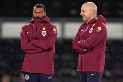 DERBY, ENGLAND - OCTOBER 13: Ashley Cole, Assistant Head Coach of England, and Lee Carsley, Head Coach of England, looks on prior to the 2027 UEFA European Under-21 Championship Qualifier match between England and Andorra at Pride Park on October 13, 2025 in Derby, England.  (Photo by Nathan Stirk/Getty Images)