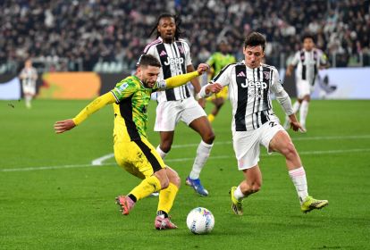TURIN, ITALY - MARCH 21: Domenico Berardi of US Sassuolo Calcio crosses the ball whilst under pressure from Andrea Cambiaso of Juventus during the Serie A match between Juventus FC and US Sassuolo Calcio at Allianz Stadium on March 21, 2026 in Turin, Italy. (Photo by Valerio Pennicino/Getty Images)