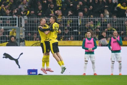 DORTMUND, GERMANY - MARCH 14: Luca Reggiani of Borussia Dortmund celebrates scoring his team's second goal with teammate Julian Ryerson during the Bundesliga match between Borussia Dortmund and FC Augsburg at Signal Iduna Park on March 14, 2026 in Dortmund, Germany. (Photo by Fabio Deinert/Getty Images)