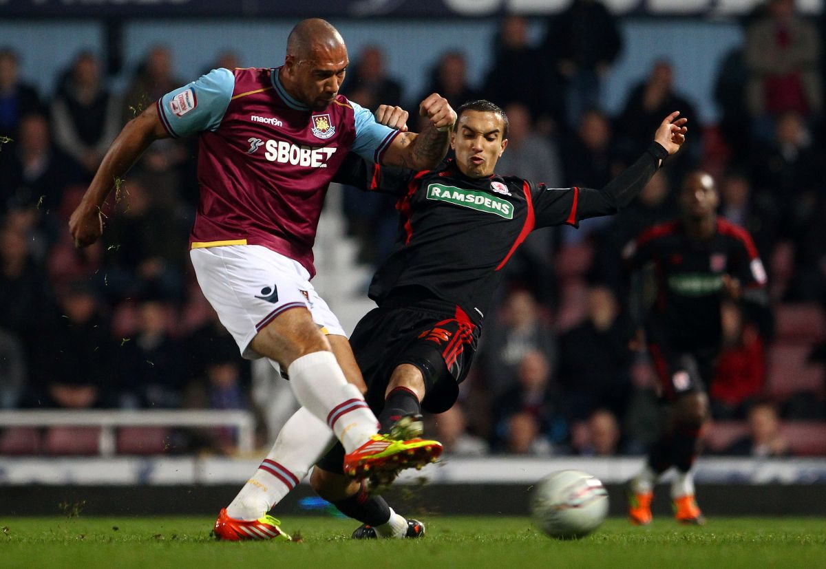 LONDON, ENGLAND - MARCH 20: John Carew of West Ham shoots at goal as Seb Hines of Middlesbrough tries to block during the npower Championship match between West Ham United and Middlesbrough at Boleyn Ground on March 20, 2012 in London, England. (Photo by Julian Finney/Getty Images)
