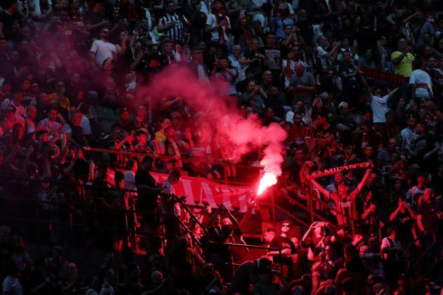 MILAN, ITALY - APRIL 26: Fans of AC Milan are seen with a lit red flare inside the stadium prior to the Serie A match between AC Milan and Juventus FC at Giuseppe Meazza Stadium on April 26, 2026 in Milan, Italy. (Photo by Marco Luzzani/Getty Images)