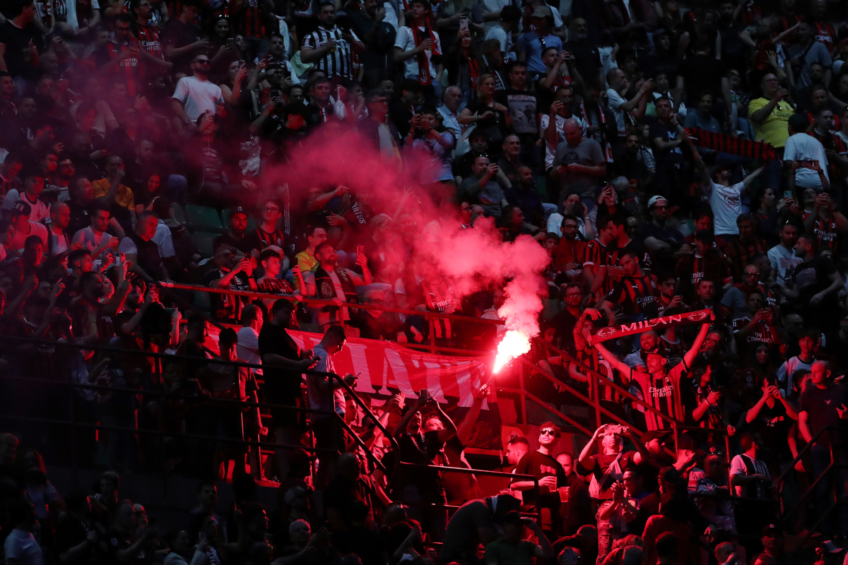 MILAN, ITALY - APRIL 26: Fans of AC Milan are seen with a lit red flare inside the stadium prior to the Serie A match between AC Milan and Juventus FC at Giuseppe Meazza Stadium on April 26, 2026 in Milan, Italy. (Photo by Marco Luzzani/Getty Images)