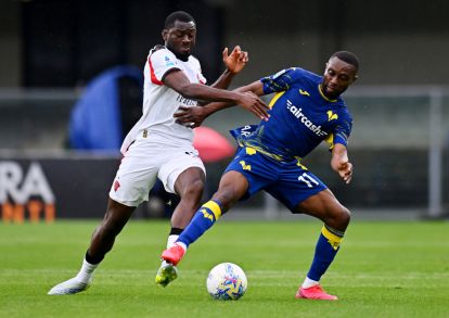 VERONA, ITALY - APRIL 19: Youssouf Fofana of AC Milan is challenged by Jean-Daniel Akpa Akpro of Hellas Verona during the Serie A match between Hellas Verona FC and AC Milan at Stadio Marcantonio Bentegodi on April 19, 2026 in Verona, Italy. (Photo by Alessandro Sabattini/Getty Images)