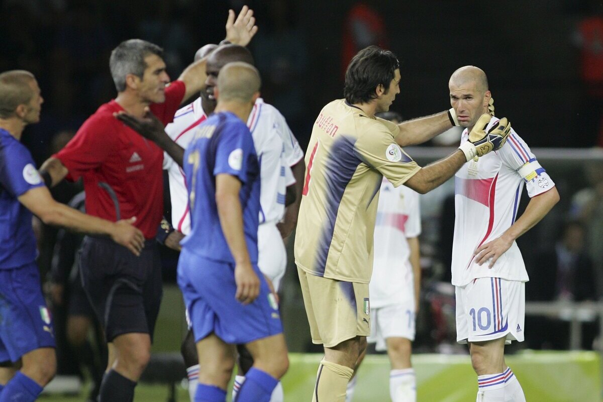 BERLIN - JULY 09: Goalkeeper Gianluigi Buffon (2nd L) of Italy consoles Zinedine Zidane (R) of France, as he is shown the red card by Referee Horacio Elizondo of Argentina during the FIFA World Cup Germany 2006 Final match between Italy and France at the Olympic Stadium on July 9, 2006 in Berlin, Germany. (Photo by Andreas Rentz/Bongarts/Getty Images)