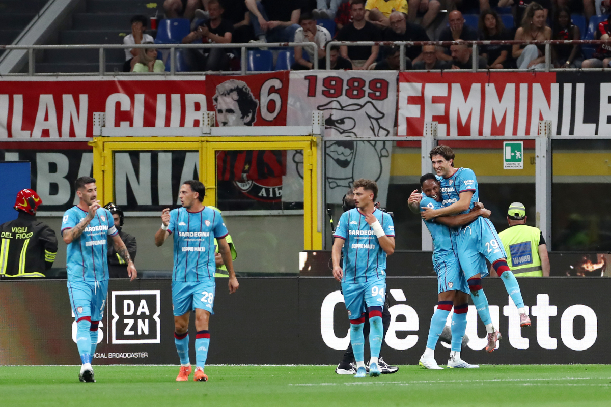 MILAN, ITALY - MAY 24: Gennaro Borrelli of Cagliari celebrates scoring his team's first goal with teammates during the Serie A match between AC Milan and Cagliari Calcio at the Giuseppe Meazza Stadium on May 24, 2026 in Milan, Italy. (Photo by Marco Luzzani/Getty Images)
