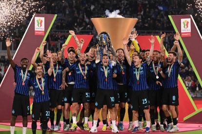 ROME, ITALY - MAY 13: Lautaro Martinez of FC Internazionale Milano lifts the Coppa Italia trophy alongside team mates after the team's victory in the Coppa Italia Final match between SS Lazio and FC Internazionale at Stadio Olimpico on May 13, 2026 in Rome, Italy. (Photo by Tullio M. Puglia/Getty Images)