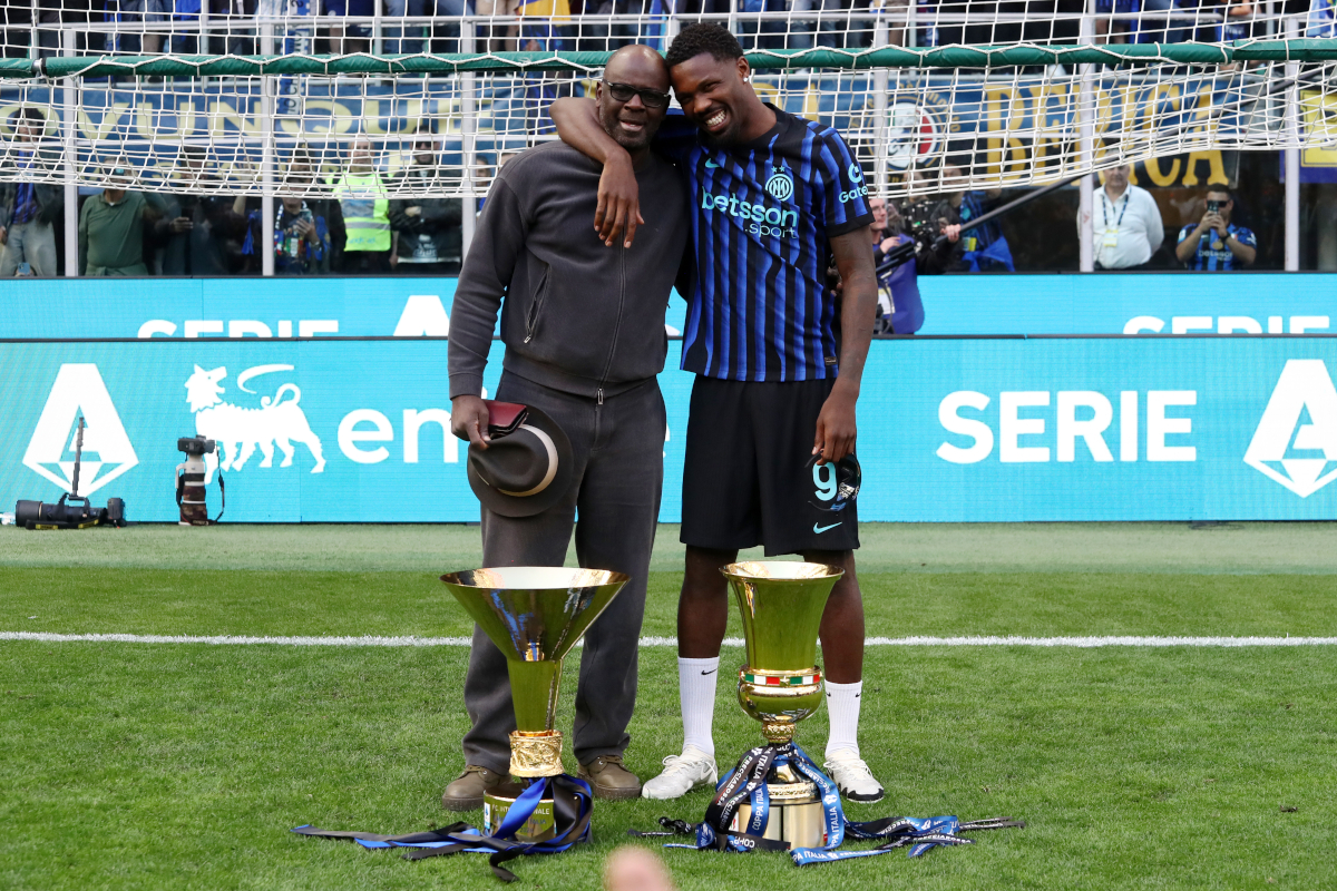 MILAN, ITALY - MAY 17: Marcus Thuram of FC Internazionale Milano poses for a photo with the Coppa Campioni d'Italia and Coppa Italia trophies alongside his father Lilian Thuram following the Serie A match between FC Internazionale and Hellas Verona FC at Giuseppe Meazza Stadium on May 17, 2026 in Milan, Italy.