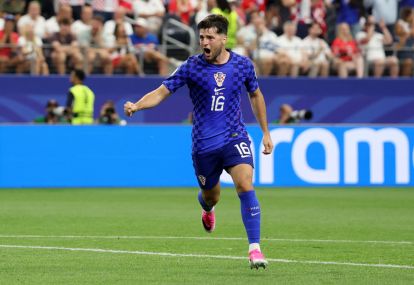ARLINGTON, TEXAS - JUNE 17: Martin Baturina #16 of Croatia celebrates scoring his team's first goal during the FIFA World Cup 2026 Group L match between England and Croatia at Dallas Stadium on June 17, 2026 in Arlington, Texas. (Photo by Michael Steele/Getty Images)