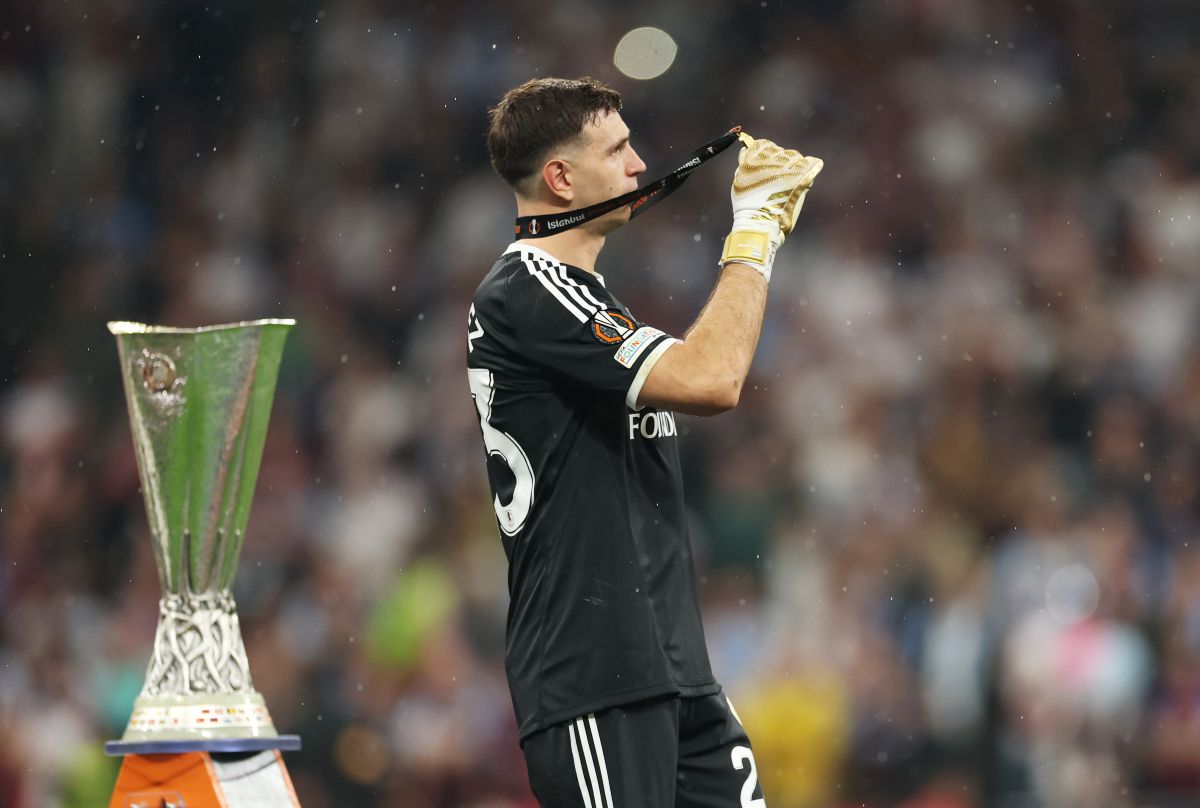 ISTAMBUL, TURQUIA - 20 DE MAIO: Emiliano Martinez, do Aston Villa, comemora com a medalha do vencedor ao passar pelo troféu da UEFA Europa League após a vitória do time durante a partida da final da UEFA Europa League 2026 entre SC Freiburg e Aston Villa FC no Besiktas Park, Turquia, em maio de 202026. (Foto de Maja Hitiz / Getty Images)