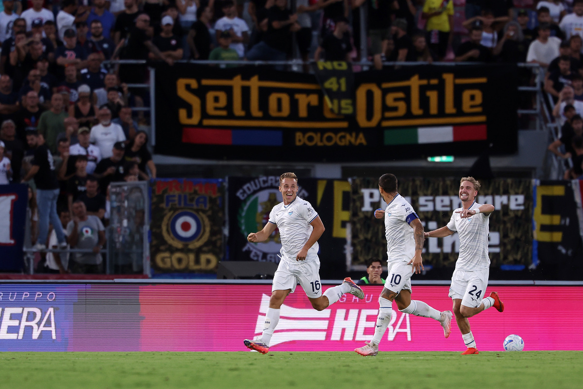 BOLOGNA, ITALY - AUGUST 24: Davide Frattesi of Lazio celebrates scoring his team’s first goal with teammates Kenneth Taylor and Mattia Zaccagni during the Serie A match between Bologna FC and SS Lazio at Stadio Renato Dall'Ara on August 24, 2026 in Bologna, Italy. (Photo by Emmanuele Ciancaglini/Getty Images)