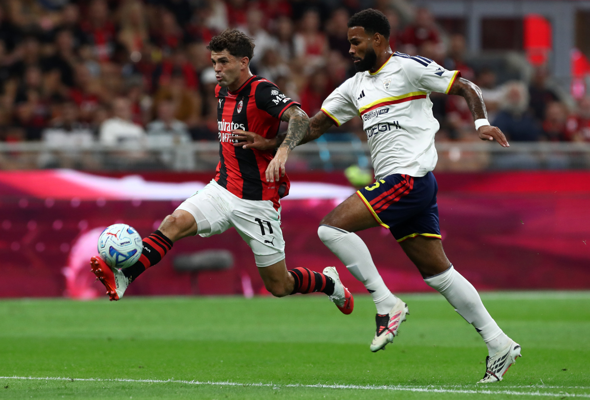 ITALY - SEPTEMBER 20: Christian Pulisic of AC Milan runs with the ball under pressure from Jamil Siebert of U.S. Lecce during the Serie A match between AC Milan and US Lecce at Stadio Giuseppe Meazza on September 20, 2026 in Italy. (Photo by Marco Luzzani/Getty Images)