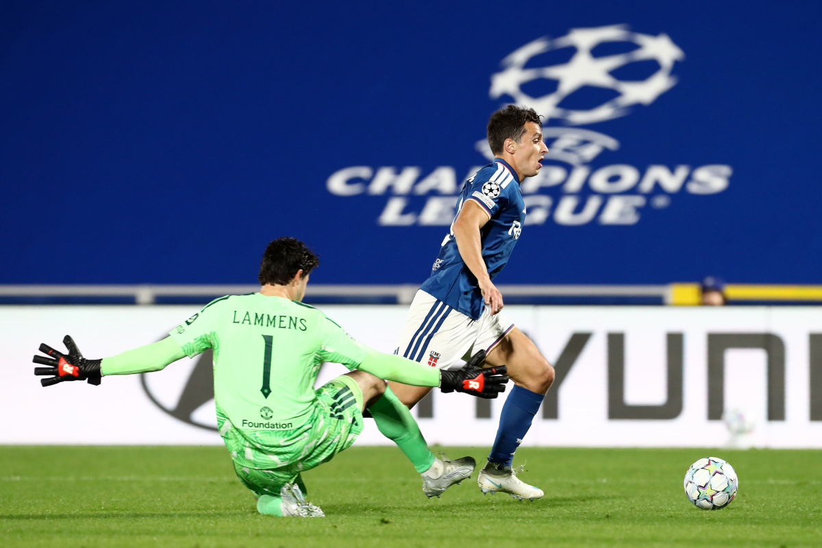 ITÁLIA - 21 DE OUTUBRO: Tasos Douvikas, do Como 1907, ataca a bola sob pressão de Senne Lammens, do Manchester United, durante a partida da Fase MD3 da Liga dos Campeões da UEFA 2026/27. (Foto de Marco Luzani/Getty Images)